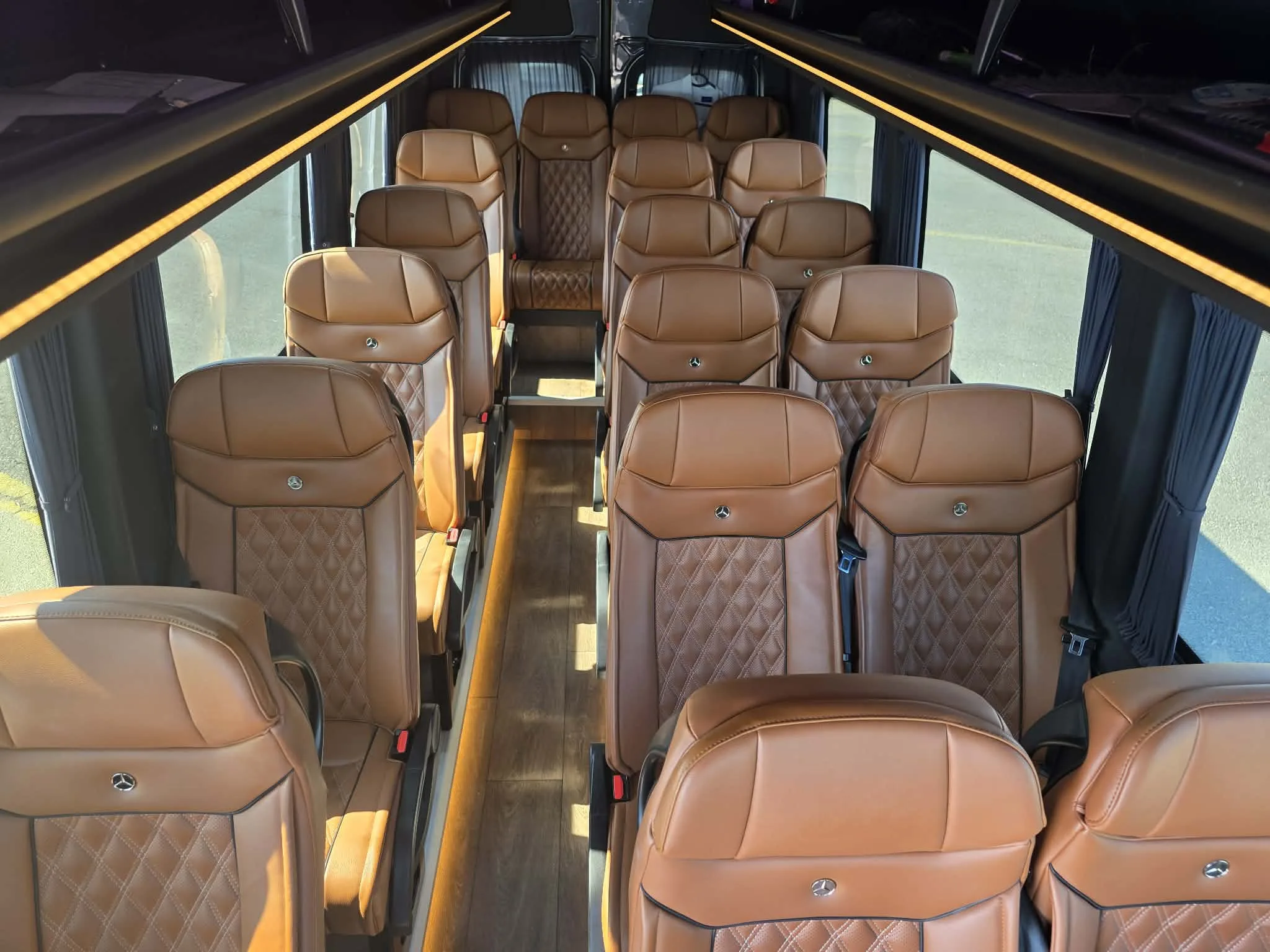 Brown leather seating inside the 19-seat Mercedes Sprinter minibus